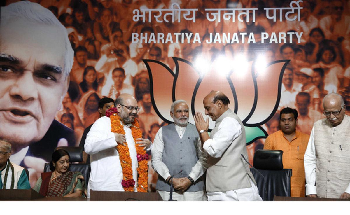 Rajnath Singh, second from right, greets newly appointed BJP president Amit Shah as Prime Minister Modi, center, and BJP senior leader L.K. Advani watch at the party’s headquarters, in New Delhi, India, Wednesday, July 9, 2014. Rajnath Singh, second from right, greets newly appointed BJP president Amit Shah as Prime Minister Modi, center, and BJP senior leader L.K. Advani watch at the party’s headquarters, in New Delhi, India, Wednesday, July 9, 2014.