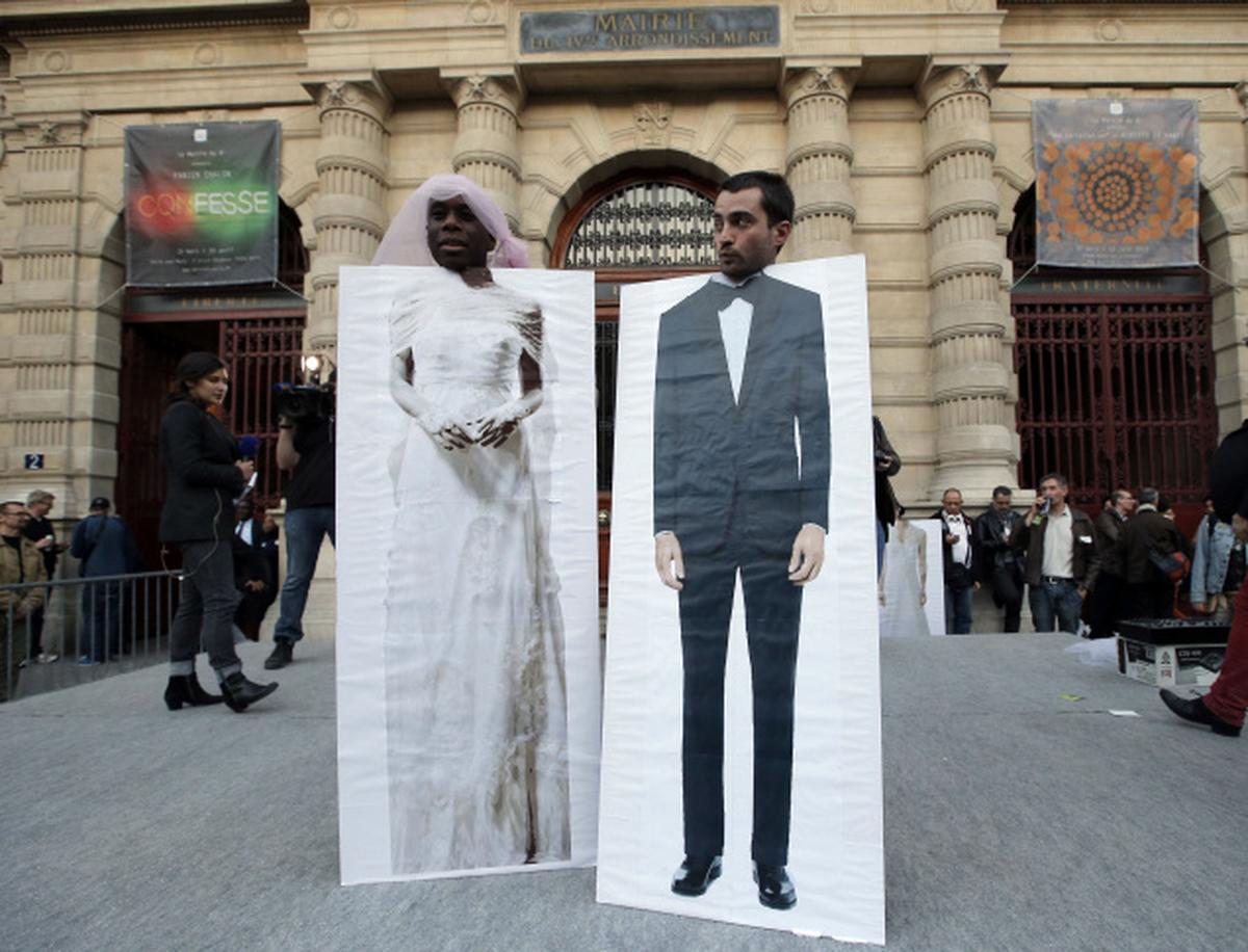 Pro-gay marriage activists pose during a gathering at Paris 4th district city hall after French lawmakers legalized same-sex marriage, Tuesday, April 23, 2013, in Paris. 