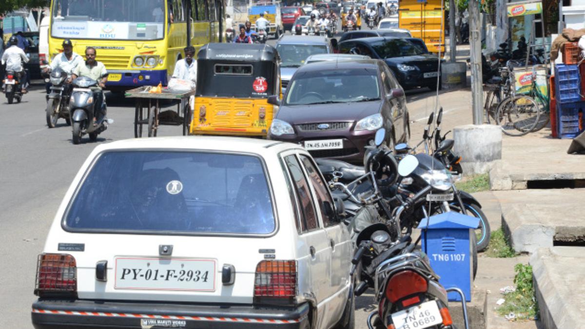 Roadside parking leaves Shastri Road in a traffic gridlock