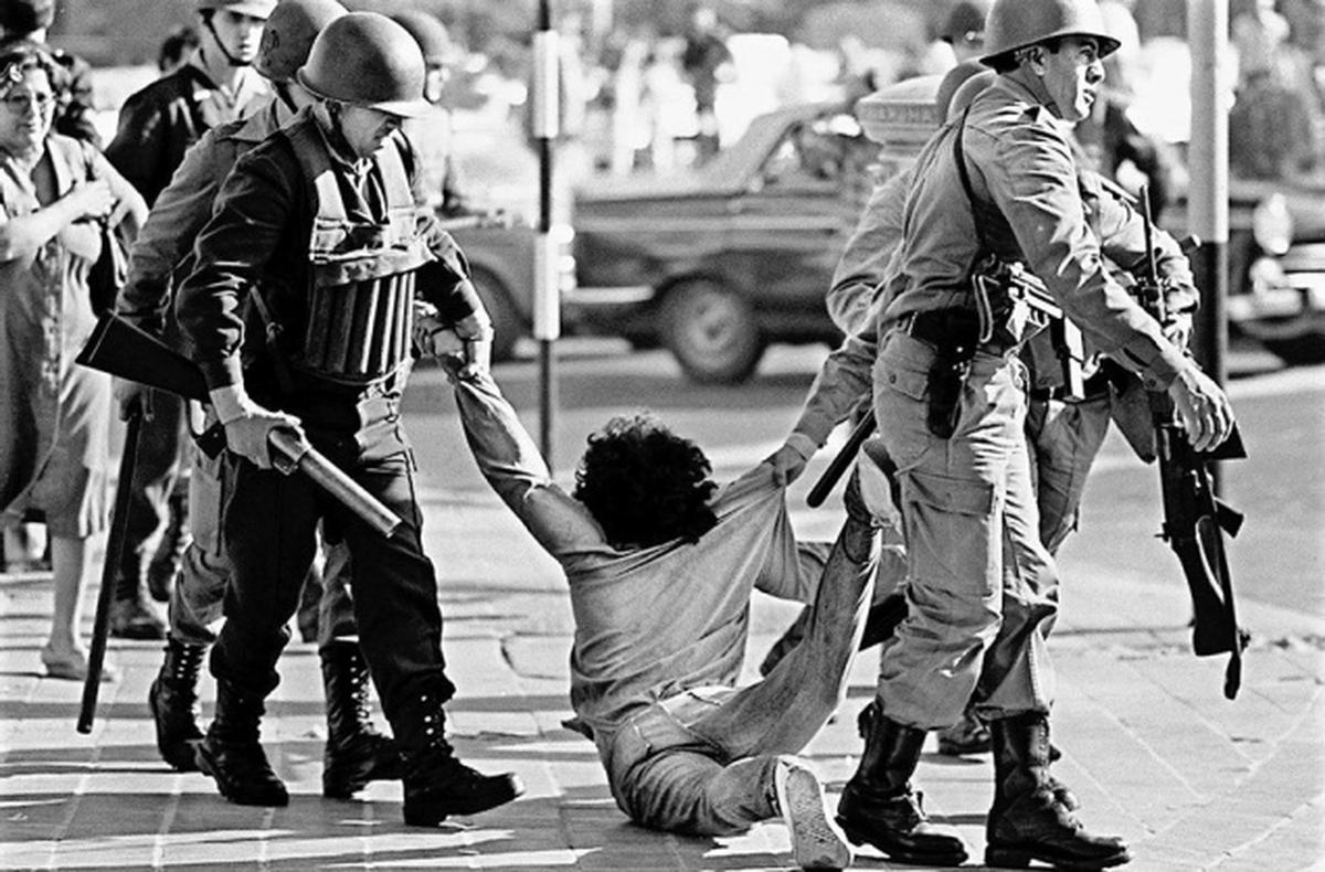 Picture taken 30 March 1982 of a worker who is being arrested during a protest against Argentine dictatorship (1976-1983) in Buenos Aires. _Participants in Operation Condor, in which six South American dictatorships collaborated to torture and assassinate their opponents, will face judgment May 27, 2016, four decades after their actions and three years into their trial.