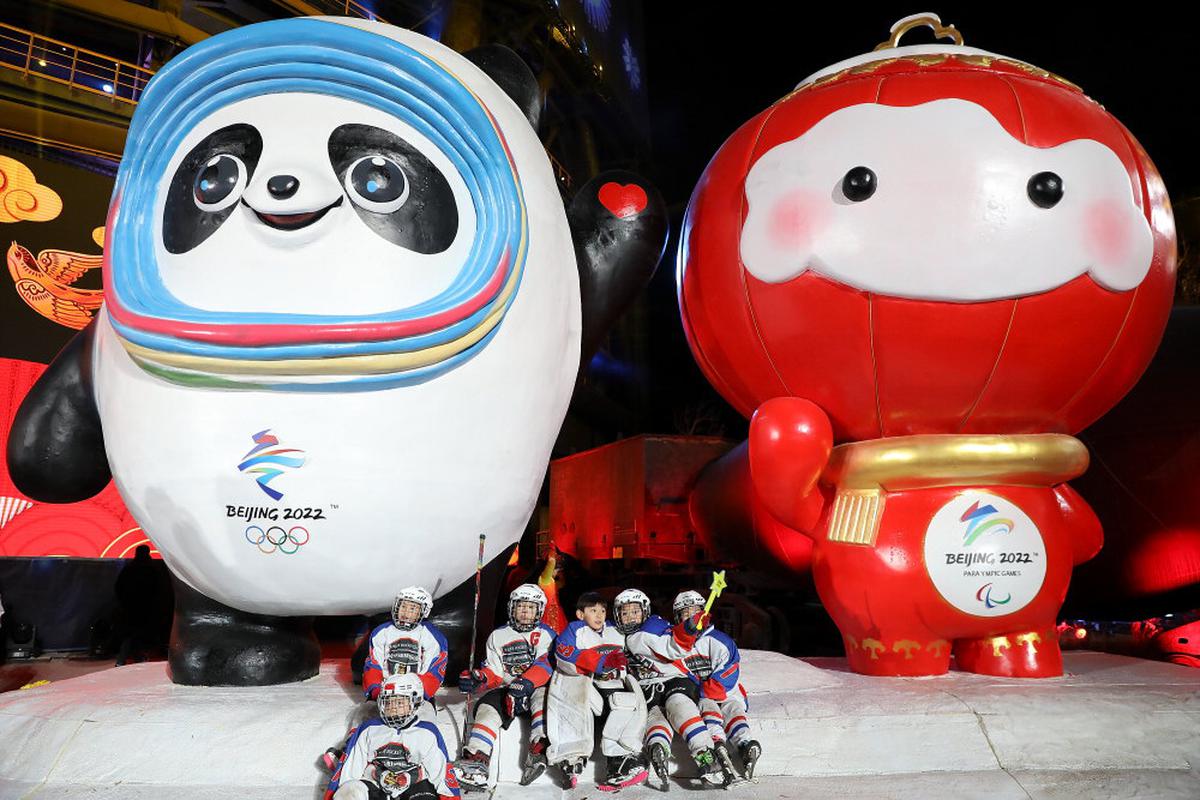 Young hockey players take a photo with mascots of the 2022 Olympic and Paralympic Winter Games, Bing Dwen Dwen and Shuey Rhon Rhon during a New Year’s Eve event at Shougang Park in Beijing, China. 