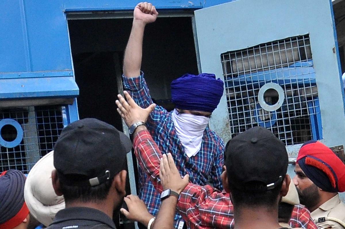 Sandeep Singh Sunny, who allegedly shot dead the politician while he was staging a protest outside a temple in the city on November 4, being produced before a local court. 