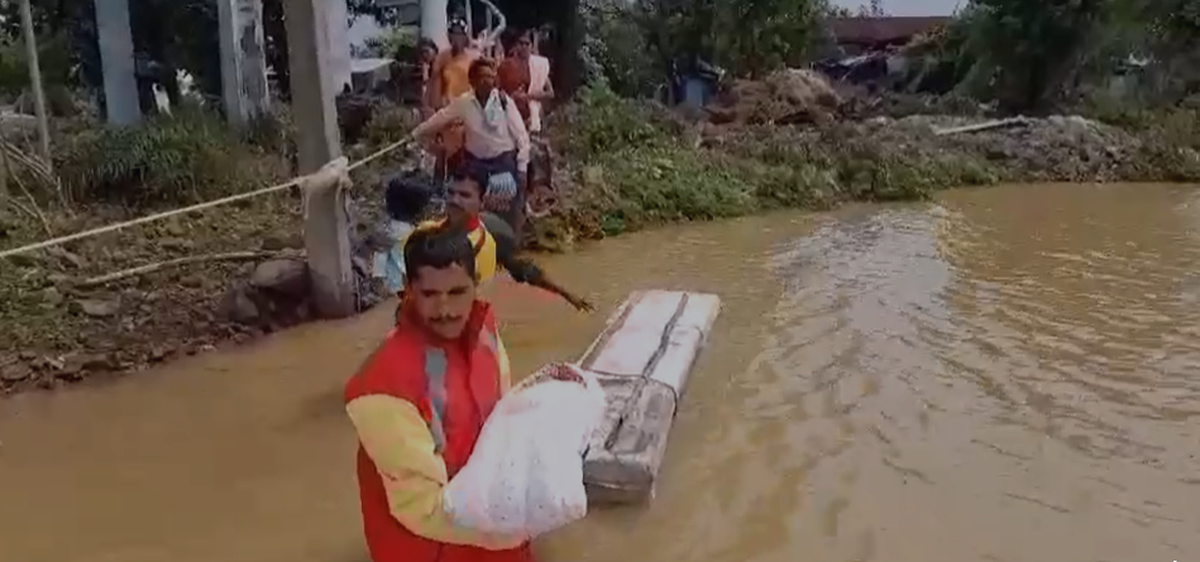 Telangana Disaster Response and Fire Services Department rescuing a new born among other people.