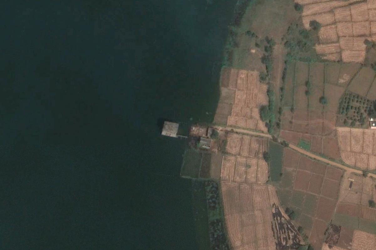 A satellite image of the building with water from the Malkapur Lake completely surrounding it.