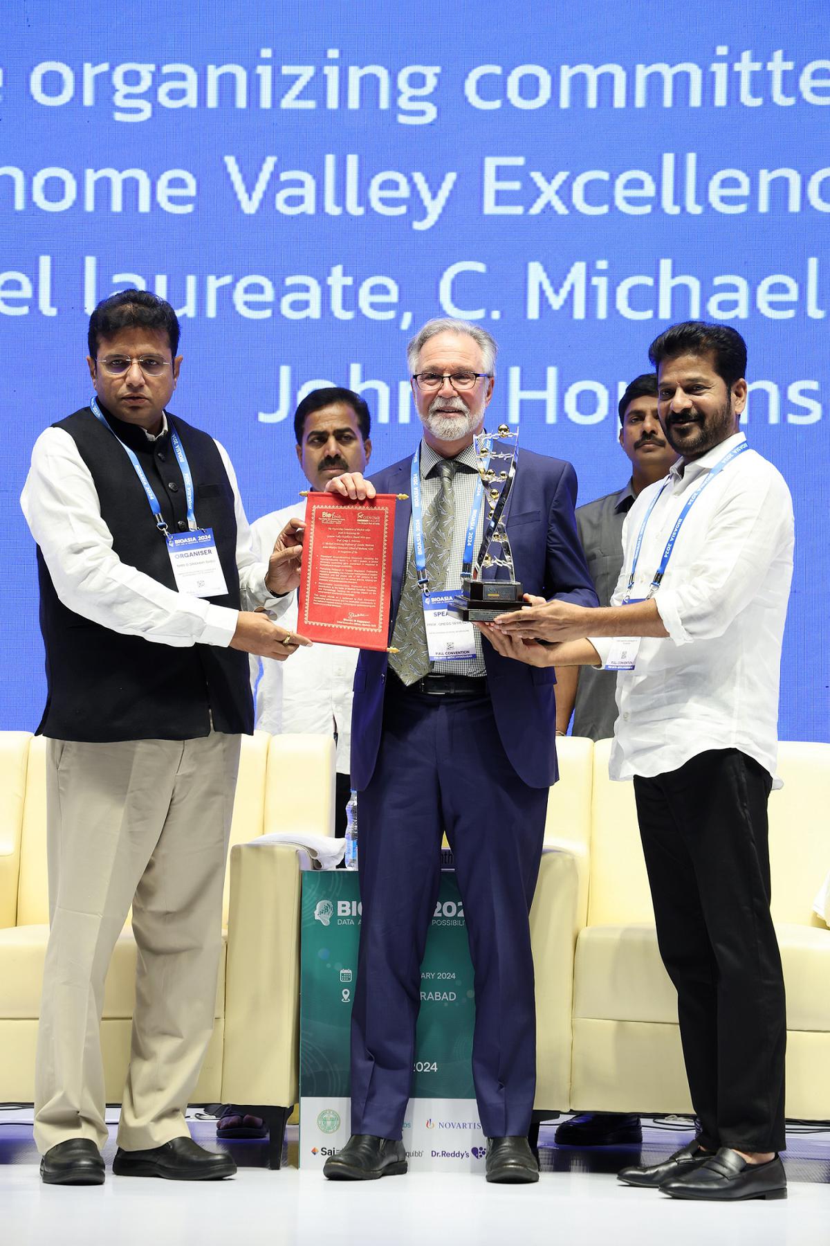 Telangana Chief Minister A. Revanth Reddy and Industries Minister D. Sridhar Babu present Genome Valley excellence award to Nobel laureate and Professor at the Johns Hopkins School of Medicine Greg Semenza, at BioAsia2024 held in Hyderabad on February 27, 2024.
