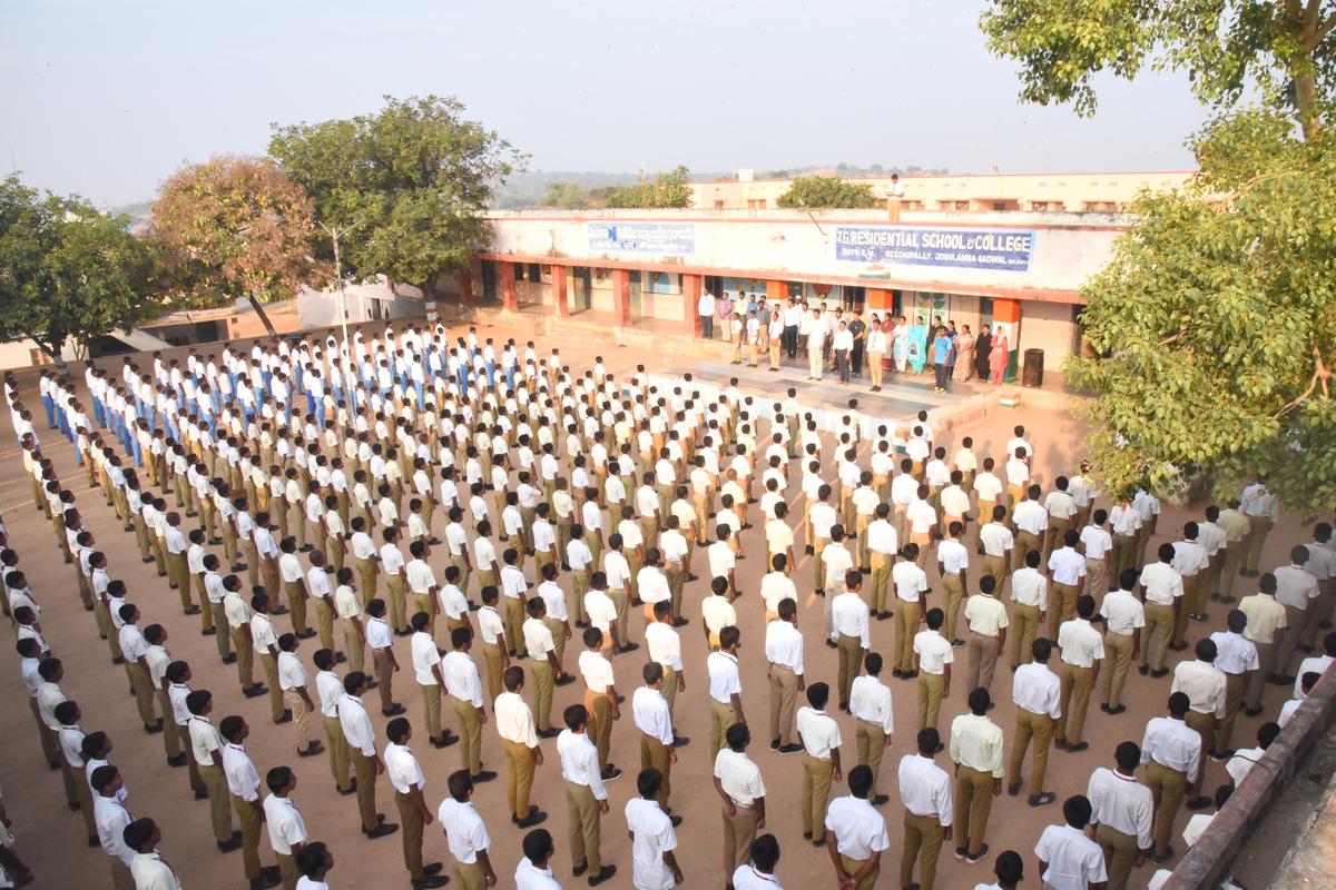 Gadwal District Collector B.M. Santosh participating in the morning prayer along with students.