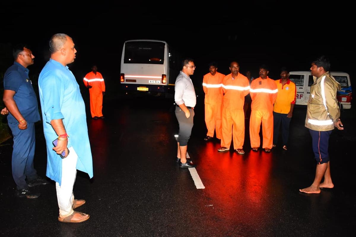 Rajanna Sircilla Collector Sandeep Kumar Jha (first from left) and Superintendent of Police Geete Mahesh Babasaheb monitoring efforts to rescue a cattle grazer stranded in a swollen stream at Lingannapet village in Gambhiraopet mandal on Wednesday night. Rajanna Sircilla Collector Sandeep Kumar Jha (first from left) and Superintendent of Police Geete Mahesh Babasaheb monitoring efforts to rescue a cattle grazer stranded in a swollen stream at Lingannapet village in Gambhiraopet mandal on Wednesday night.