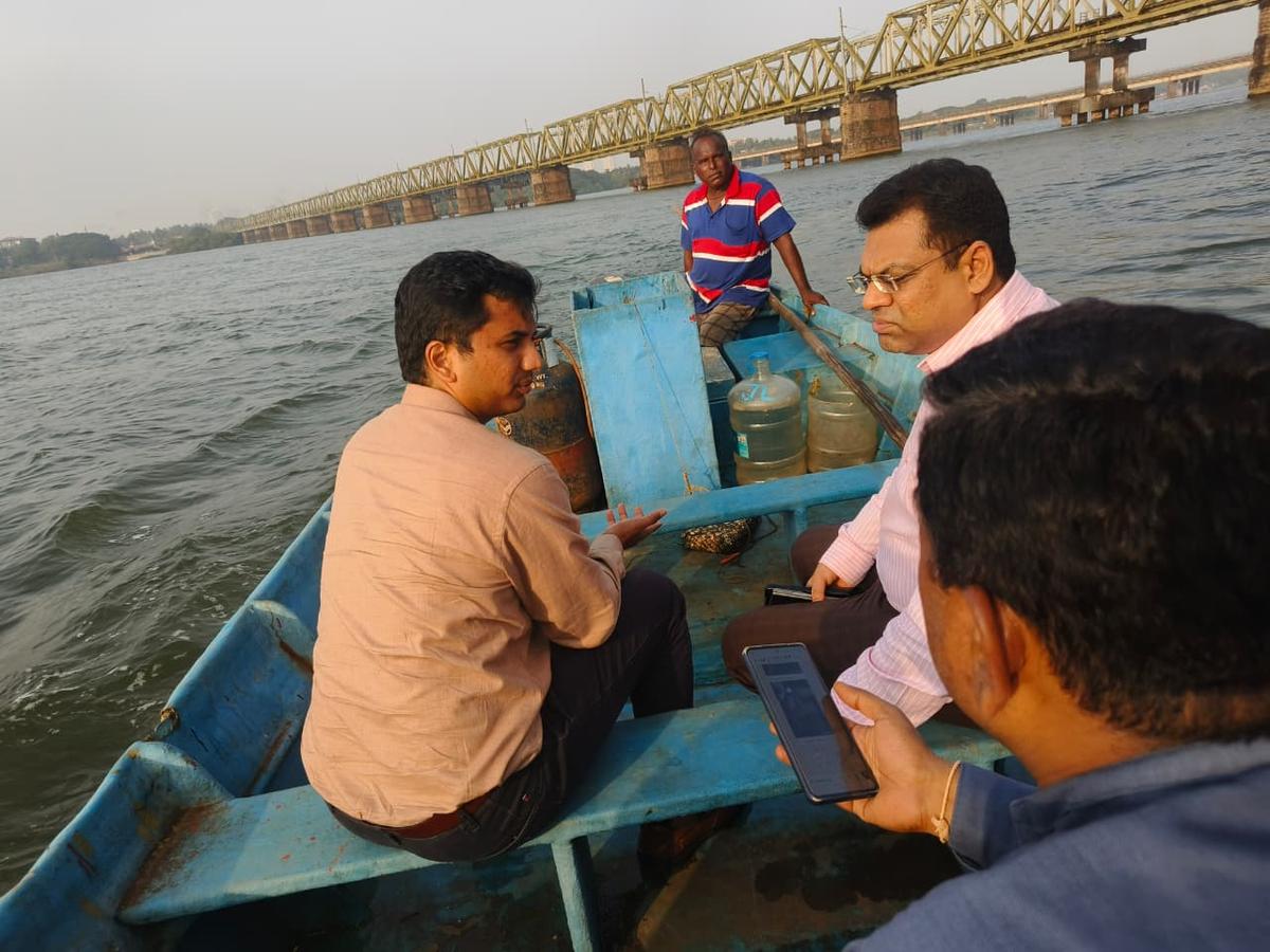 Dakshina Kannada Deputy Commissioner H.V. Darshan and Mangaluru City Corporation Commissioner Ravi Chandra Naik travelled by a boat on the Netravathi to inspect a broken footbridge across its backwaters near Ullal Hoige in Mangaluru on Wednesday. Dakshina Kannada Deputy Commissioner H.V. Darshan and Mangaluru City Corporation Commissioner Ravi Chandra Naik travelled by a boat on the Netravathi to inspect a broken footbridge across its backwaters near Ullal Hoige in Mangaluru on Wednesday.