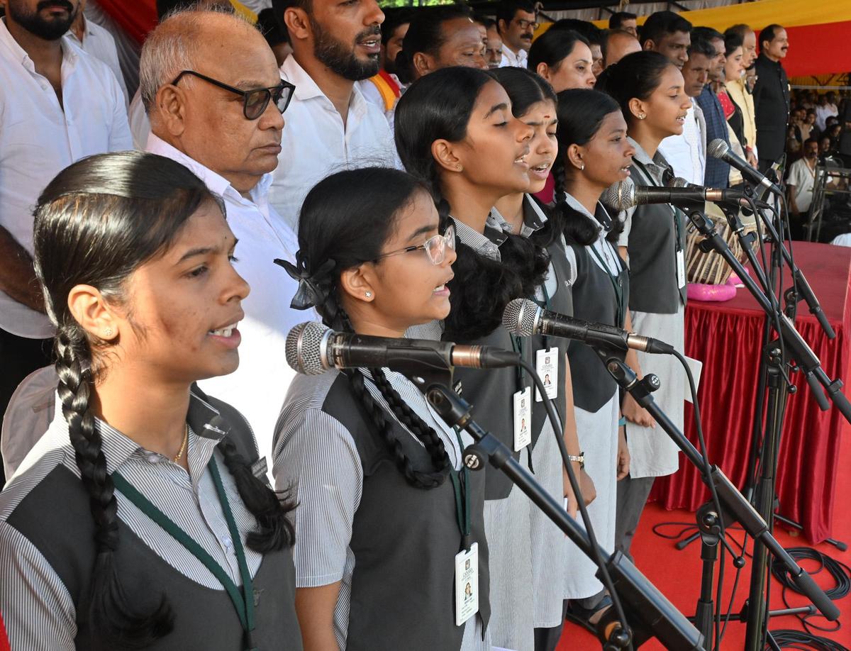 Students of Canara School singing the State anthem during the district-level Rajyotsava programme at Nehru Maidan in Mangaluru on Saturday