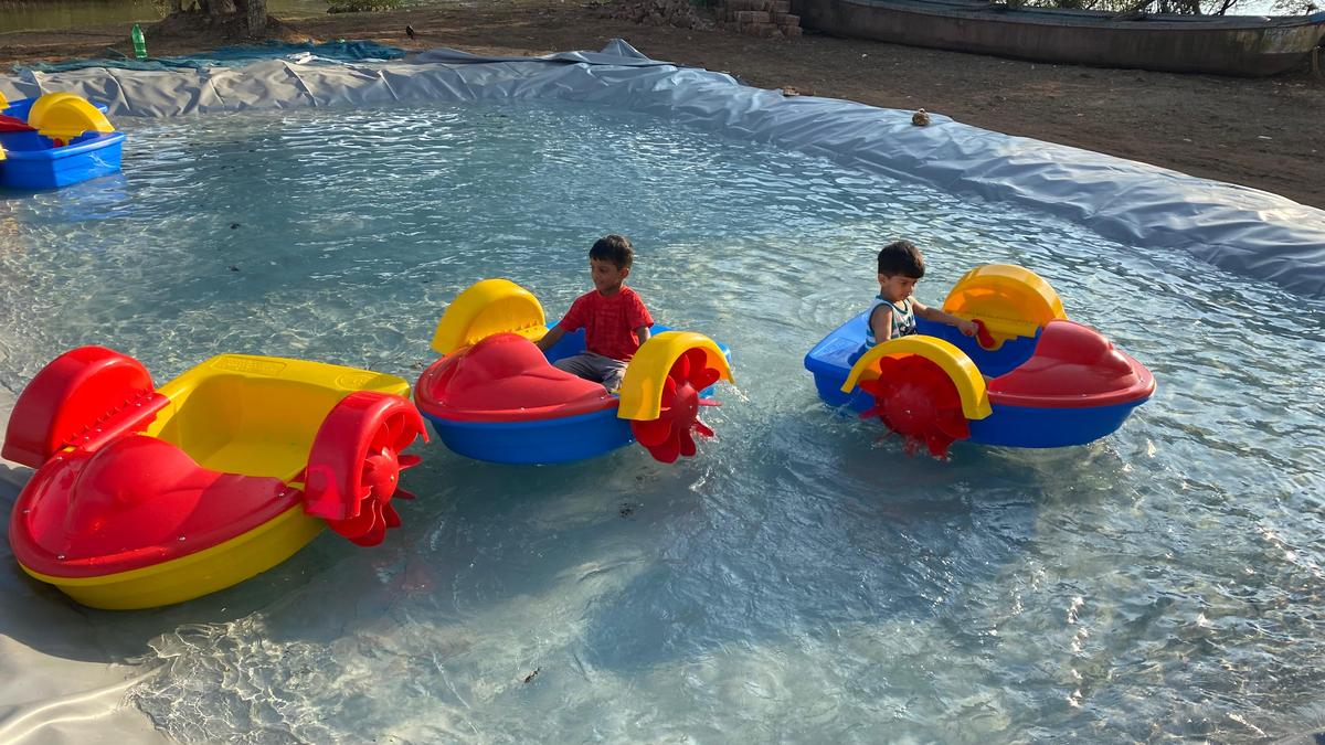 Children enjoying mini boat rides at the makeshift kids pool of the Blue Miracle Water Sports facility in Mangaluru on Sunday.