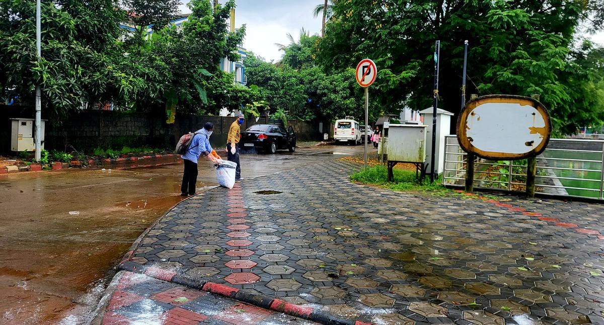 Civic workers spray bleaching powder to eliminate moss growth on the walking path around Gujjarkere after regular users complained to Mangaluru City Corporation, in Mangaluru on June 17, 2025. Civic workers spray bleaching powder to eliminate moss growth on the walking path around Gujjarkere after regular users complained to Mangaluru City Corporation, in Mangaluru on June 17, 2025.