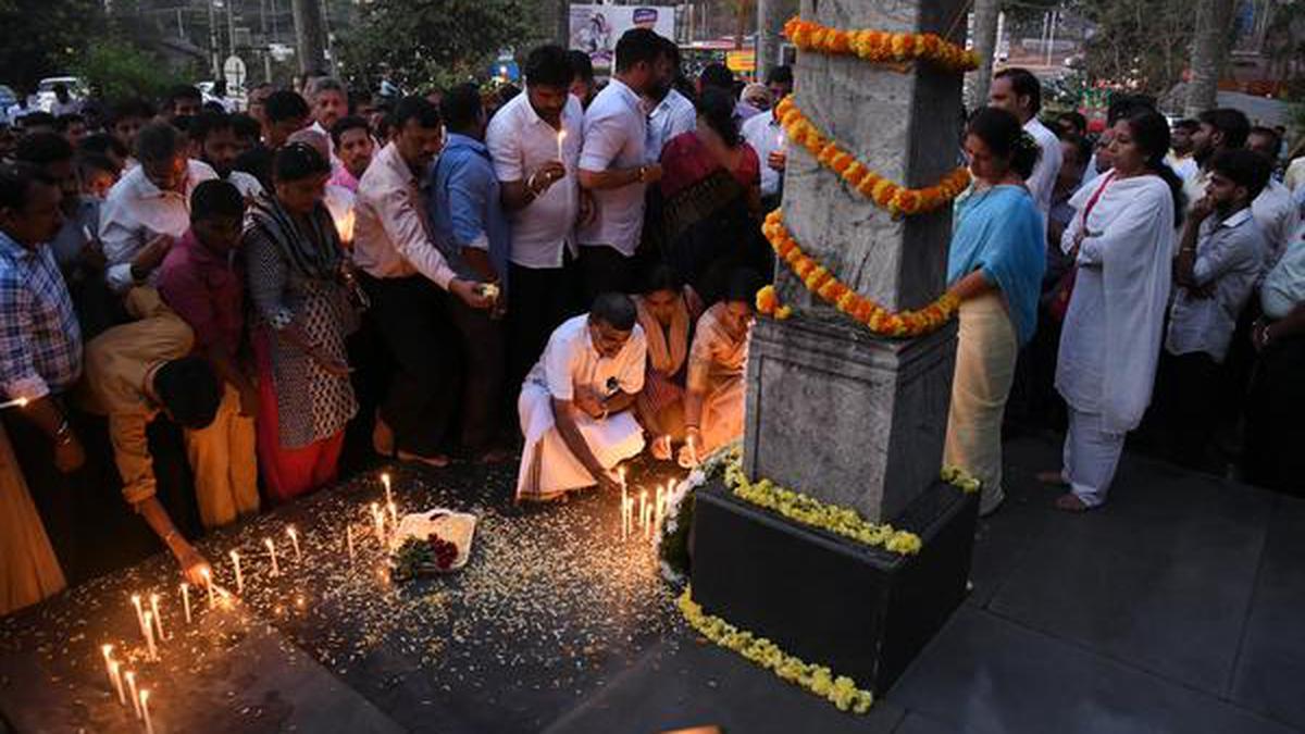 Citizens light candles for the slain