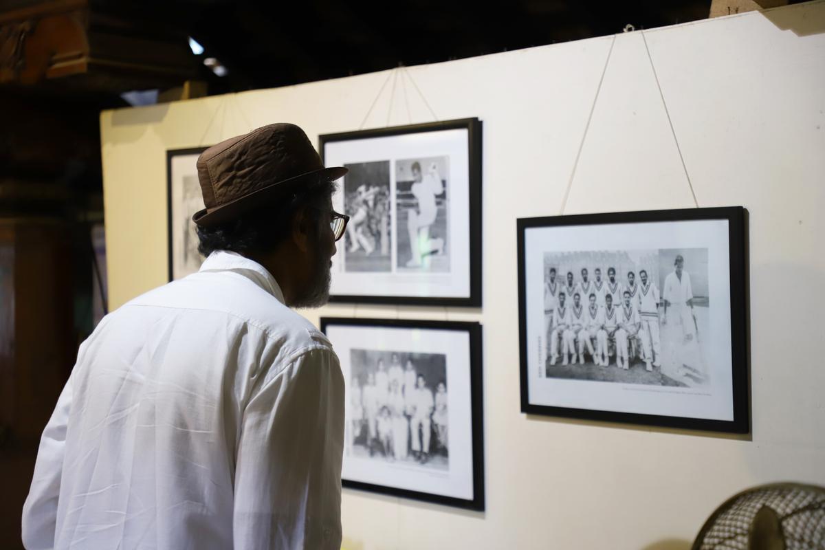 A visitor watches rare old cricket photos of Mangaluru at Kodialguthu Centre for Art and Culture on October 25.
