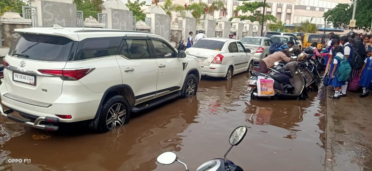 Vehicle users wading through an inundated road after sharp showers lashed Tiruchi on Thursday. 