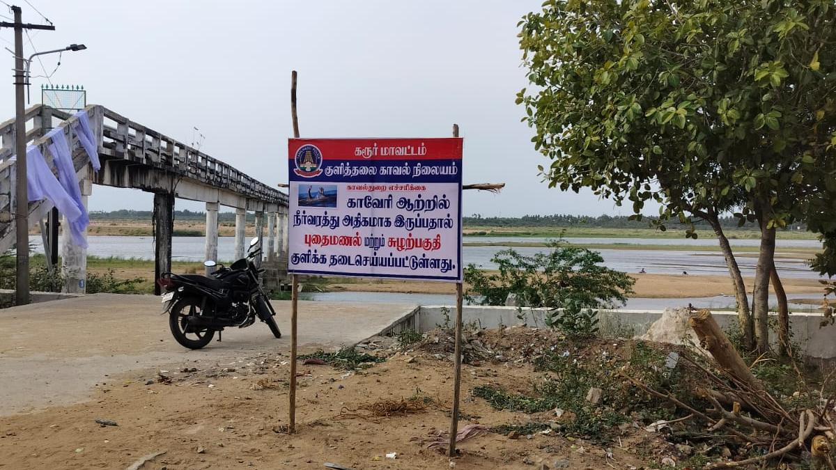 Police put up caution signboards along the Cauvery in Karur district