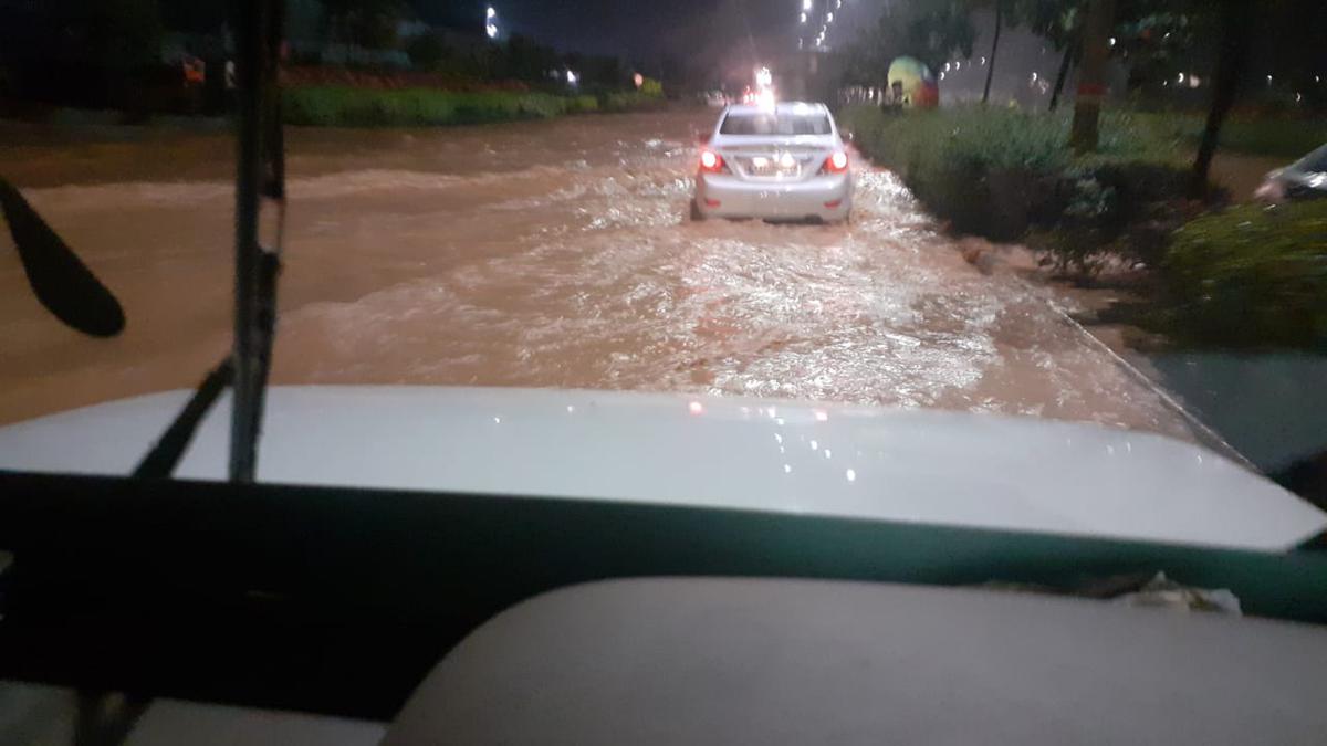 Watch | With Bangalore airport flooded, tractors ferry people - The Hindu