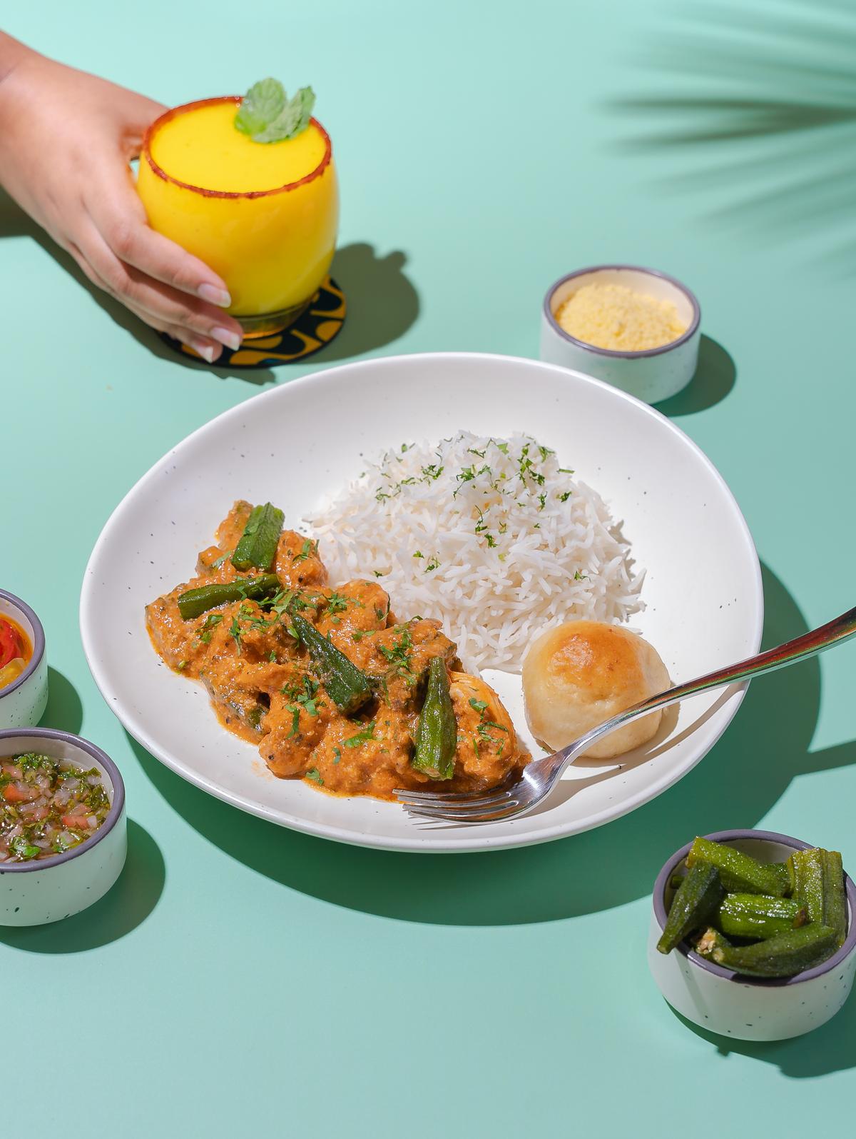 Chicken with okra stew served with Brazilian rice and cheese bread.