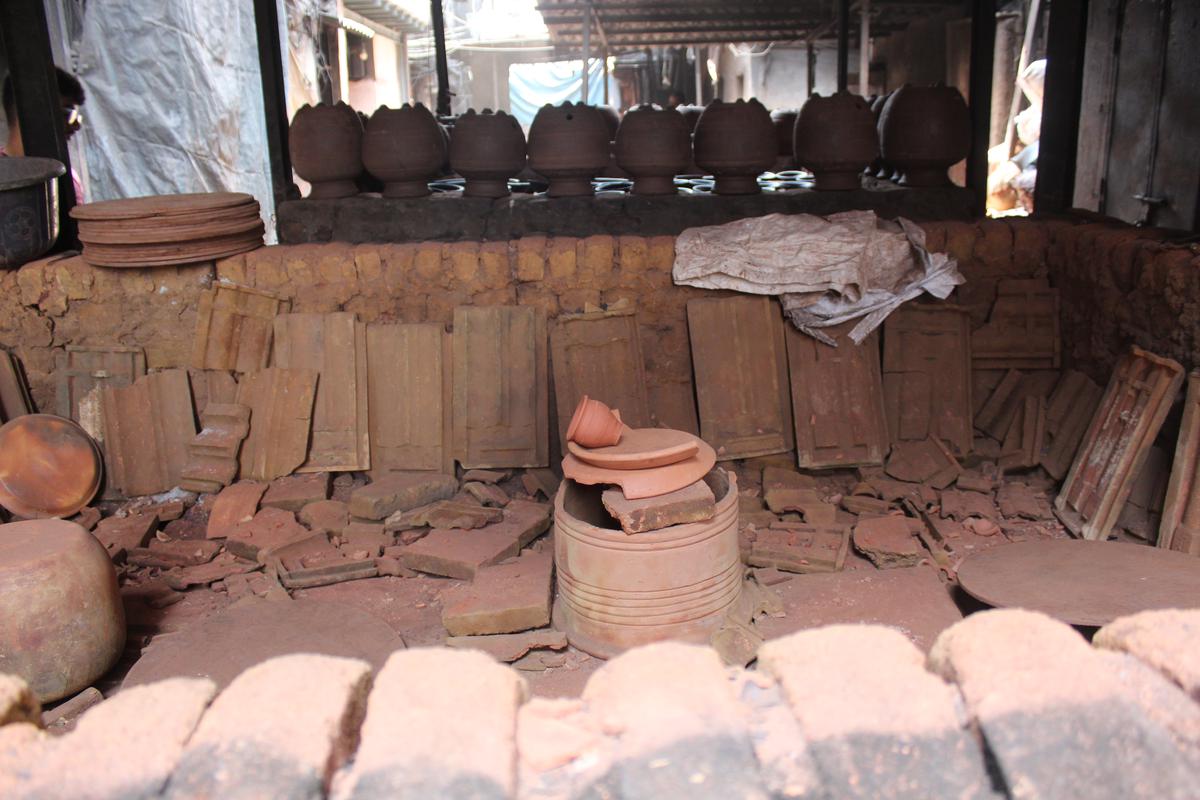 Pots kept to bake in the rectangular burner called bhatti.