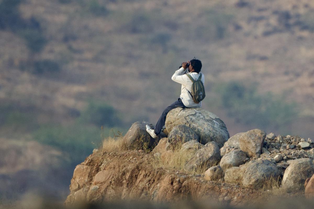 A local resident uses binoculars received from the training program to document grassland species. A local resident uses binoculars received from the training program to document grassland species.