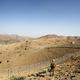 FILE PHOTO A soldier stands guard along the border fence outside the Kitton out