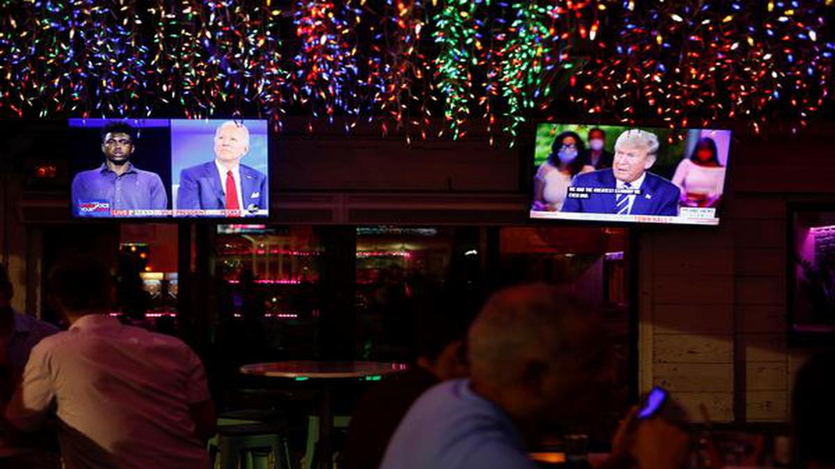 In split-screen town halls, Donald Trump and Joe Biden squabble over coronavirus response