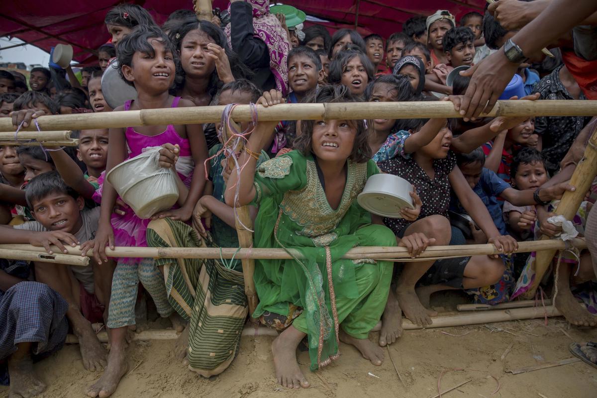 File photo: Rohingya children who crossed over from Myanmar to Bangladesh wait to receive food handouts at a refugee camp in Bangladesh, 2017.  