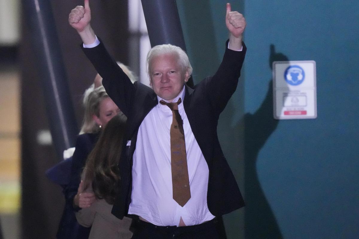 WikiLeaks founder Julian Assange gestures after landing at RAAF base in Canberra, Australia, June 26, 2024. 