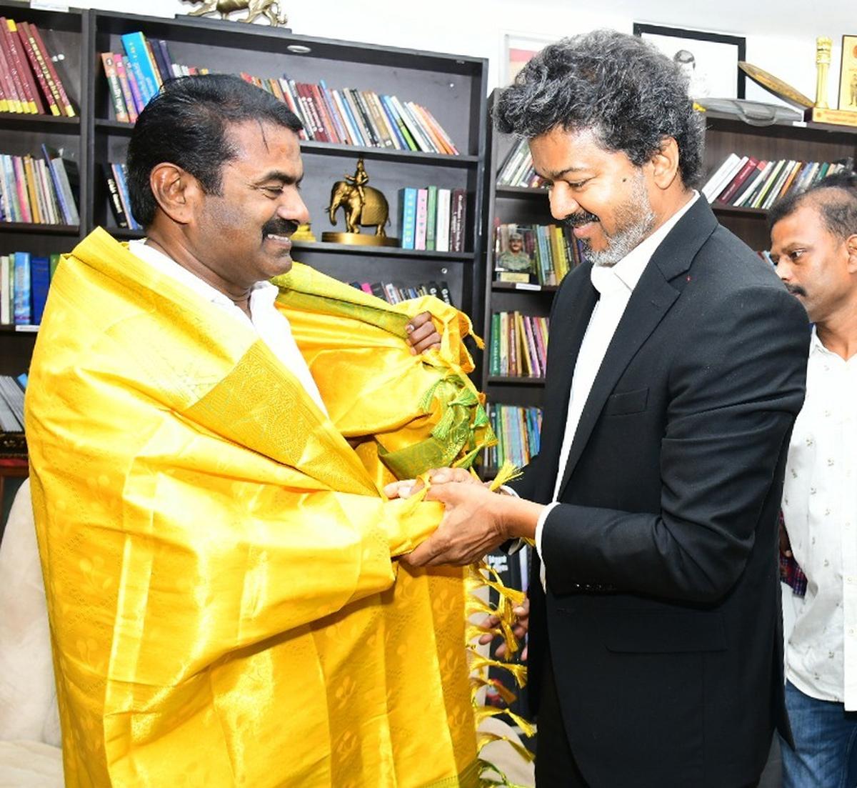 Chief Minister C. Joseph Vijay hands over a shawl to Naam Tamilar Katchi founder Seeman at his residence in Chennai on May 11, 2026.