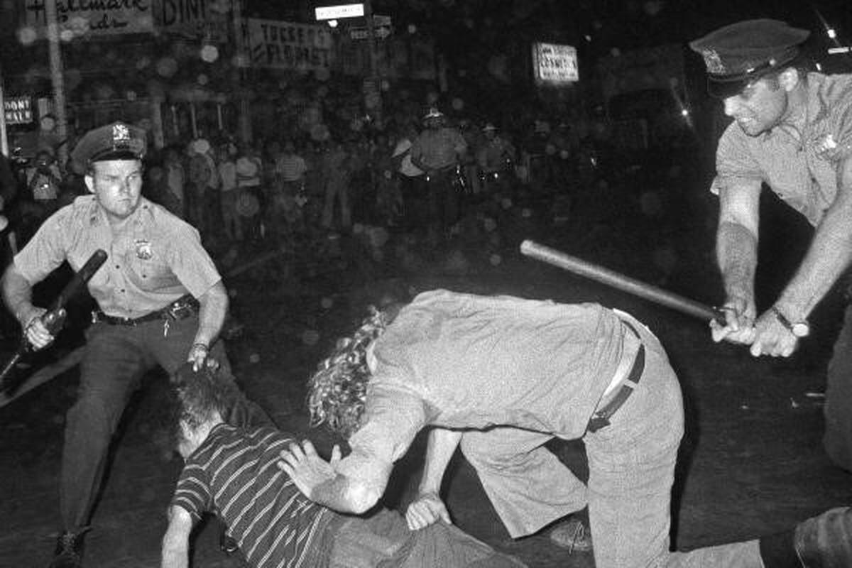 A New York City Police Department officer grabs a youth by the hair as another officer clubs a young man during a confrontation in Greenwich Village after a Gay Power march in New York, August 31, 1970. 