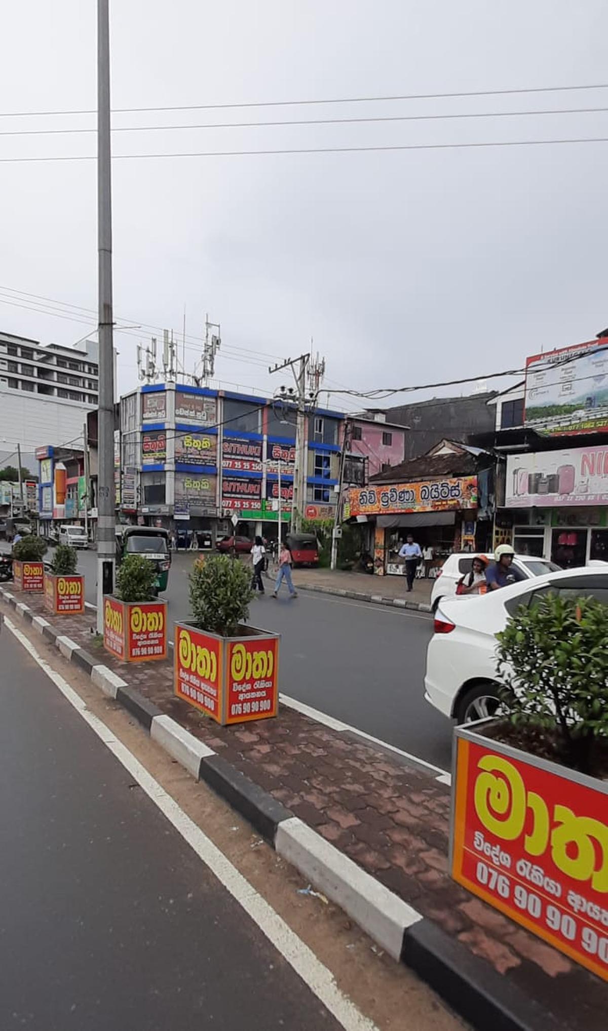 Agencies advertise overseas jobs along the road median in Kurunegala town in Sri Lanka’s North Western Province.