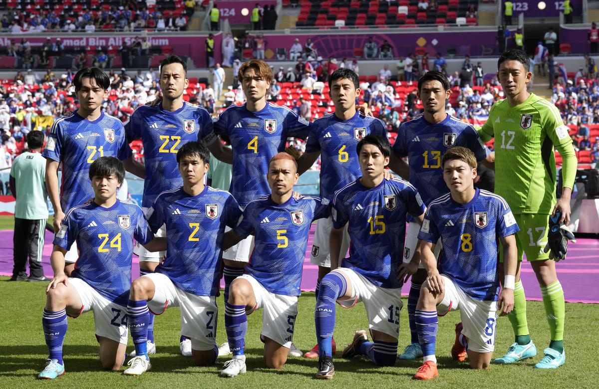 Team Japan stands for a team photo before the World Cup, group E soccer match between Japan and Costa Rica, at the Ahmad Bin Ali Stadium in Al Rayyan, Qatar, Sunday, Nov. 27, 2022. 