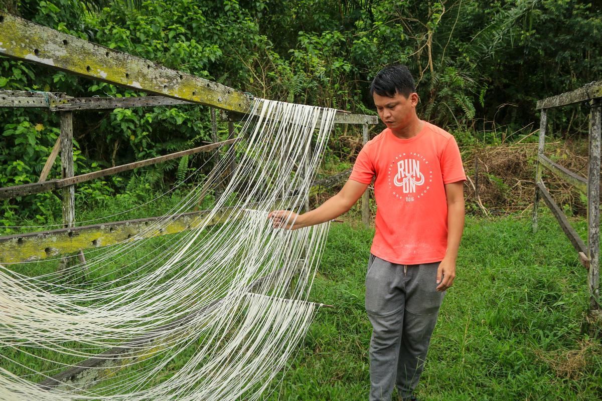 The transformation of a pile of dough into a thin strand of noodles is a fascinating scene to behold. 