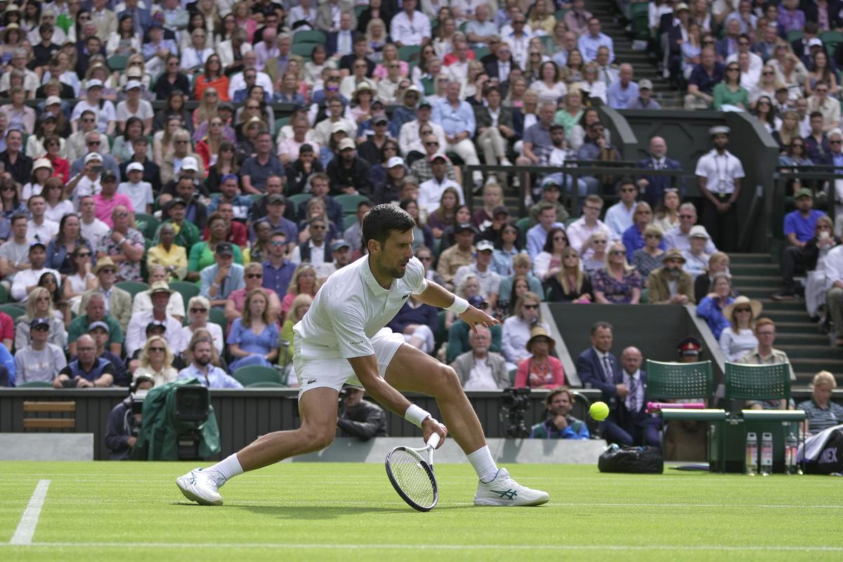 Serbia’s Novak Djokovic returns to Argentina’s Pedro Cachin during their first round men’s singles match on day one of the Wimbledon tennis championships in London, Monday, July 3, 2023.
