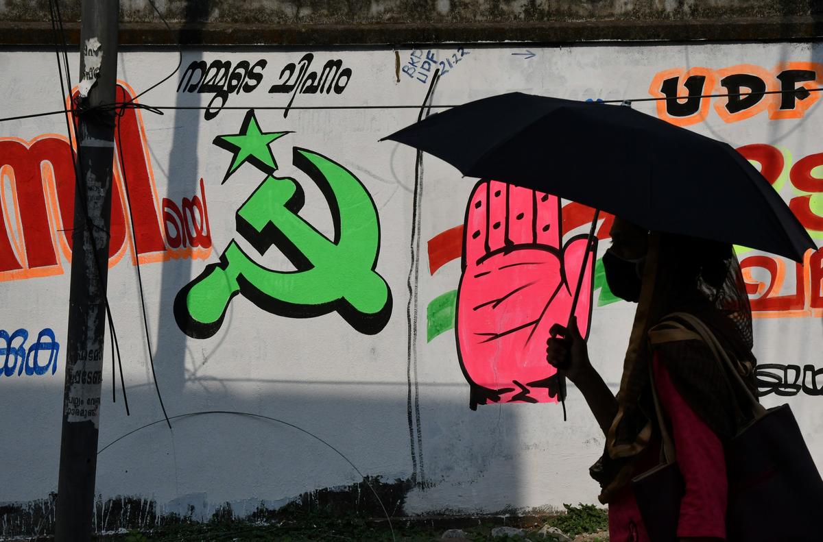 Despite hard-fought electoral battles, Kerala maintains its culture of peaceful coexistence, as seen in this Fort Kochi graffiti where CPI(M) and Congress symbols share the same wall.