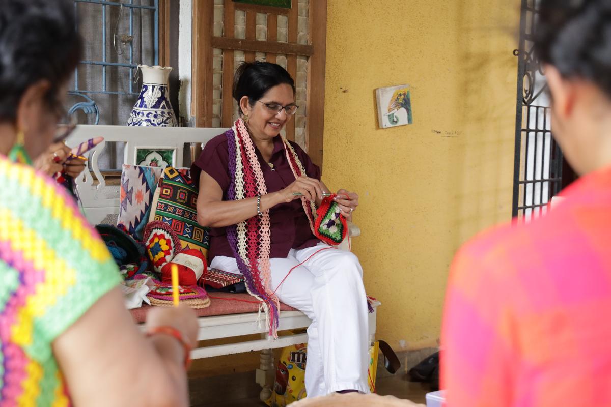 Each member of the Crochet Collective is wearing handcrafted crochet tops, scarves or earrings, as the art form is popular across the State