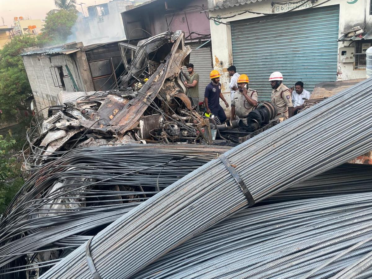 Lorry crashes into car, sets off blaze at Kurubarahalli in Bengaluru on March 27, 2026. The stretch has a steep downward slope. Police suspect that the driver lost control of the vehicle on the slope due to the heavy load.