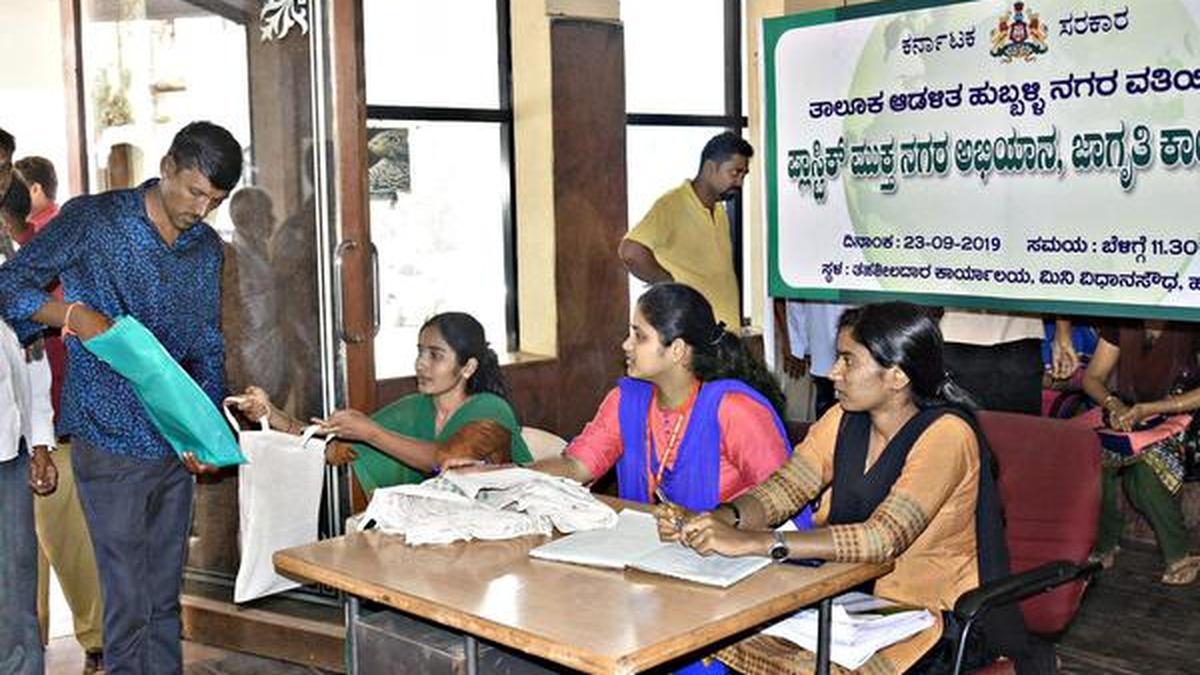 Tahsildar office staff distribute clothbags in an effort to fight use