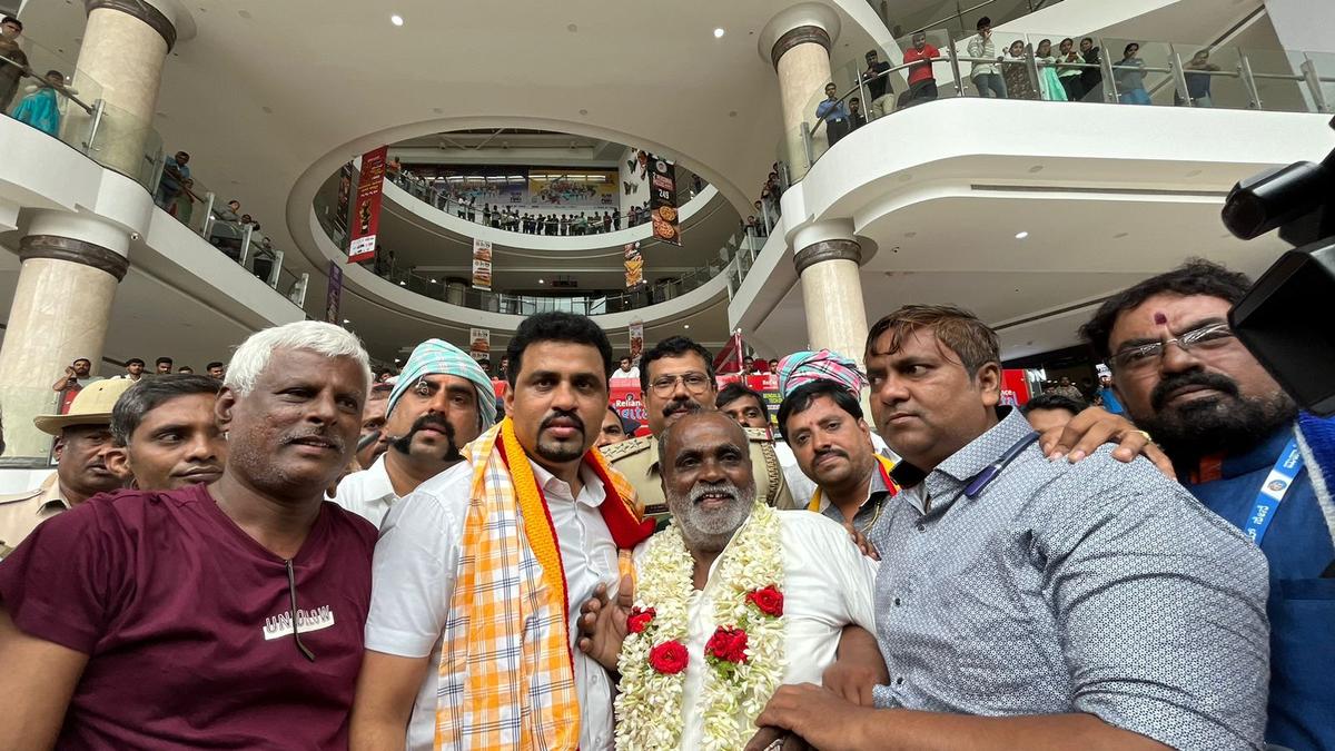 Farmer Fakeerappa, who was denied entry to G.T. Mall for wearing a panche (dhoti), was felicitated after a protest by activists in front of the mall in Bengaluru, on July 17, 2024. 