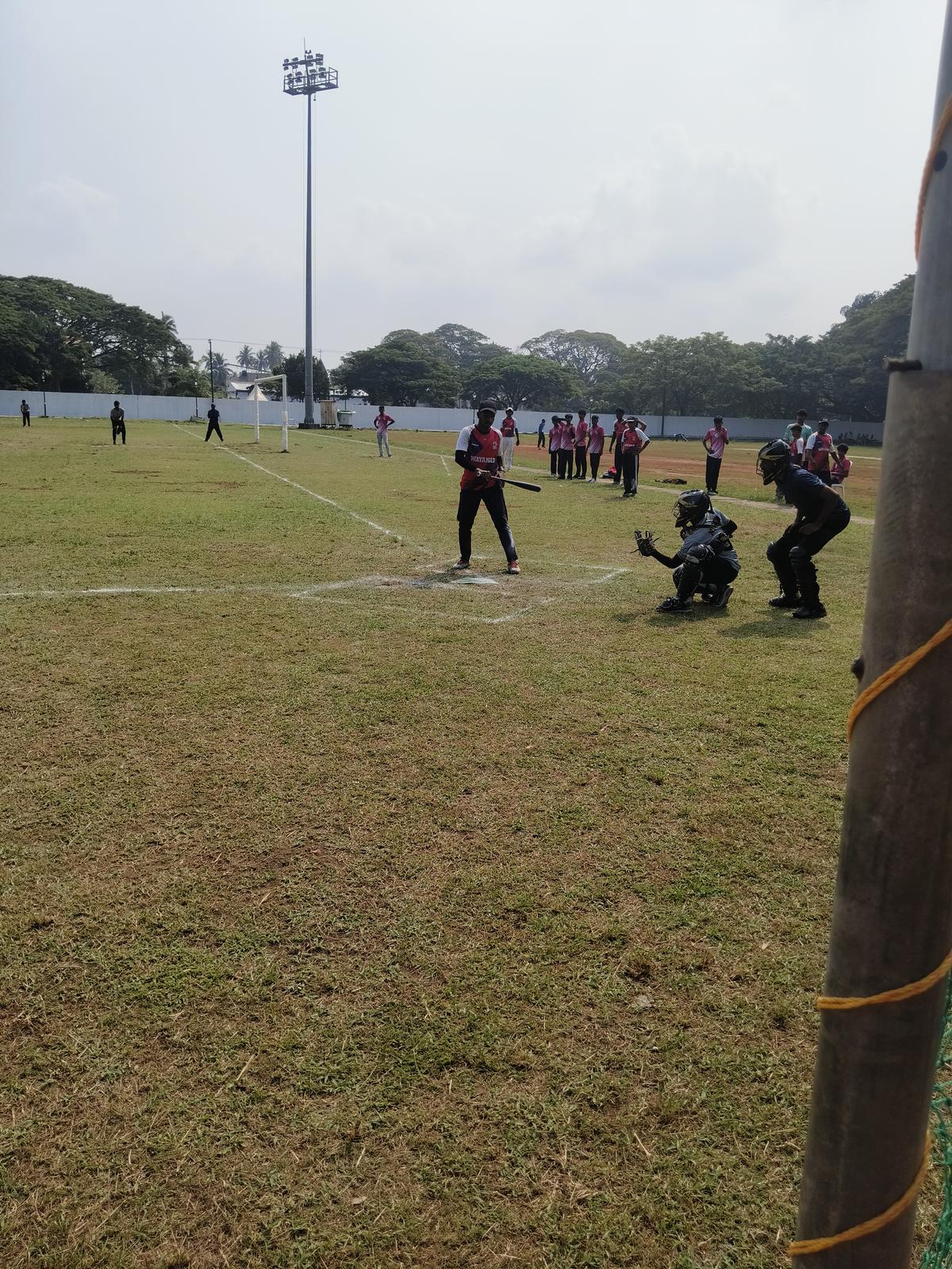 A baseball game is in progress on the Veli ground at Fort Kochi.