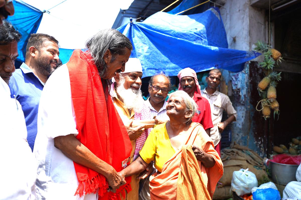 LDF candidate Pannian Raveendran greeted by an elderly woman at Chala. 