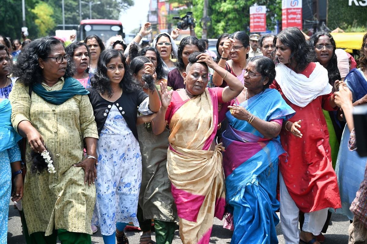 Agitating ASHA workers cut their hair in a symbolic protest against the Kerala government outside the Secretariat in Thiruvananthapuram as their agitation entered the 50th day on Monday (March 31, 2025) Agitating ASHA workers cut their hair in a symbolic protest against the Kerala government outside the Secretariat in Thiruvananthapuram as their agitation entered the 50th day on Monday (March 31, 2025)