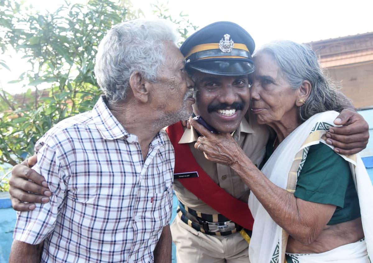 Parents of a senior civil police officer who newly joined the State police being kissed by his parents after the passing-out parade at MSP grounds, Malappuram, on Monday.