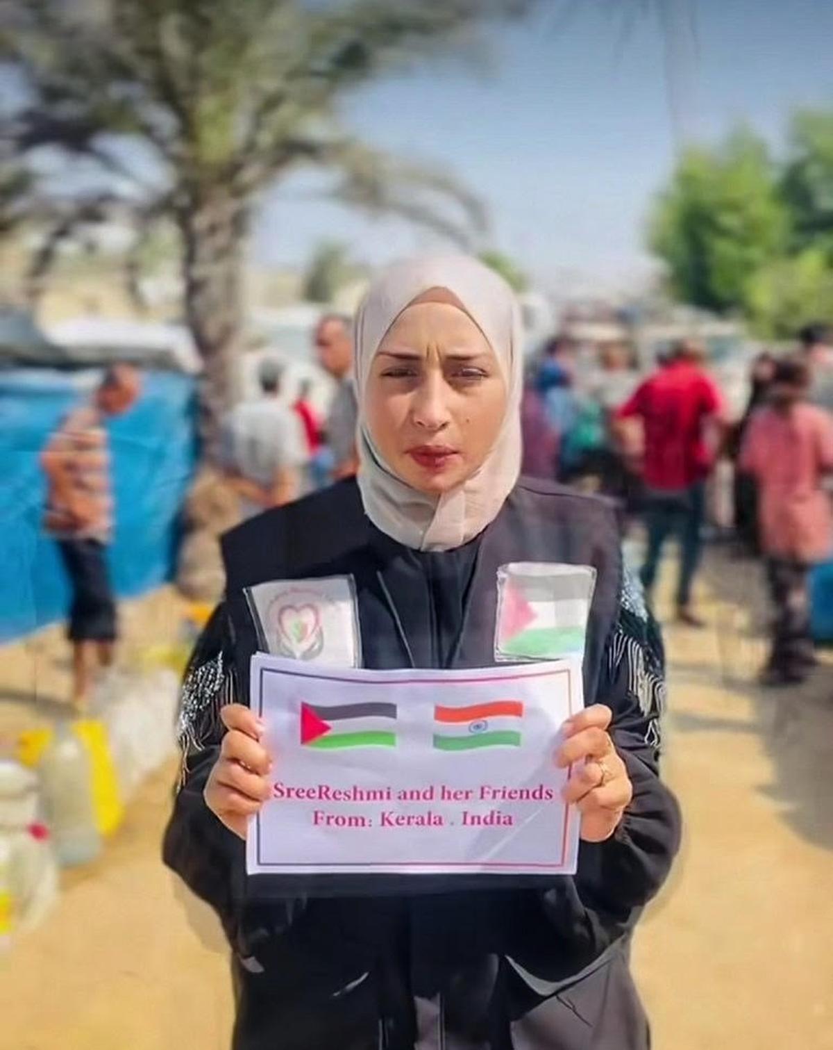 A Palestinian woman displays a notice thanking Sreereshmi and her friends for their help. A Palestinian woman displays a notice thanking Sreereshmi and her friends for their help.