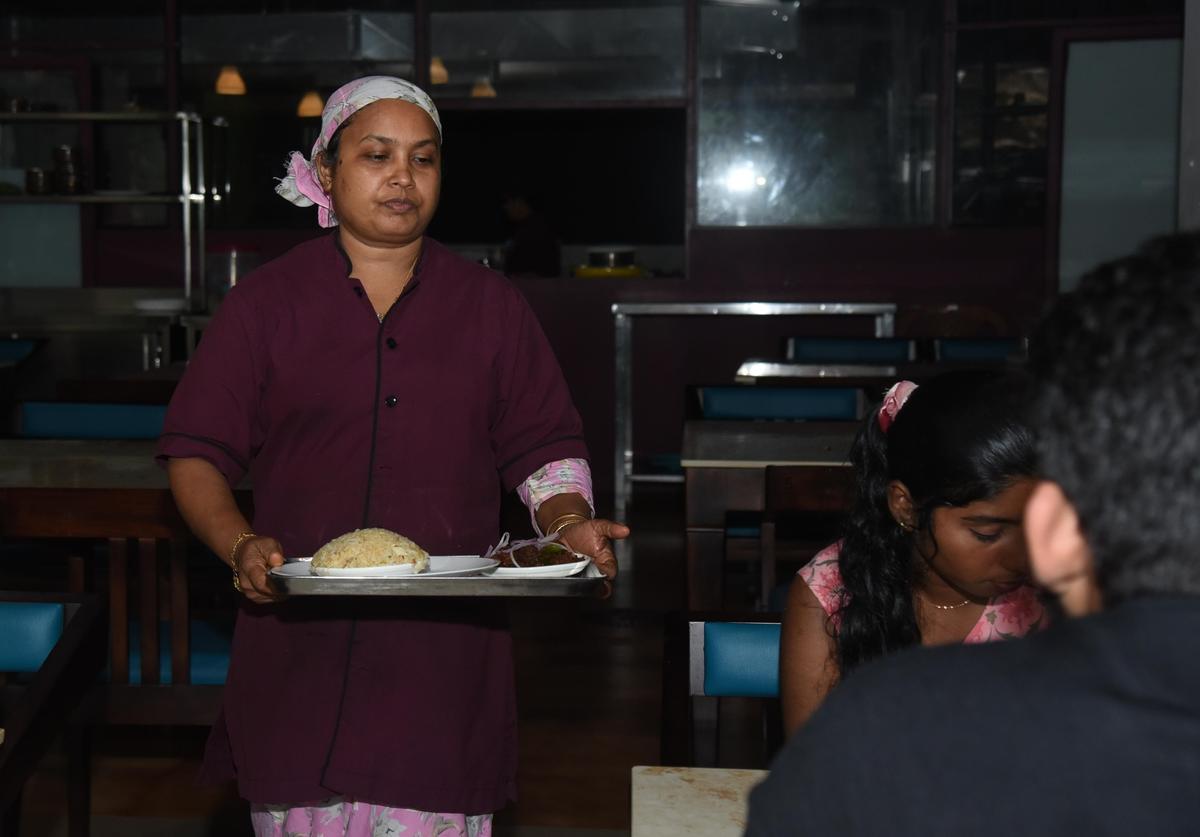Shareefa serving food to a customer at her Cafe Kudumbashree Shareefa serving food to a customer at her Cafe Kudumbashree