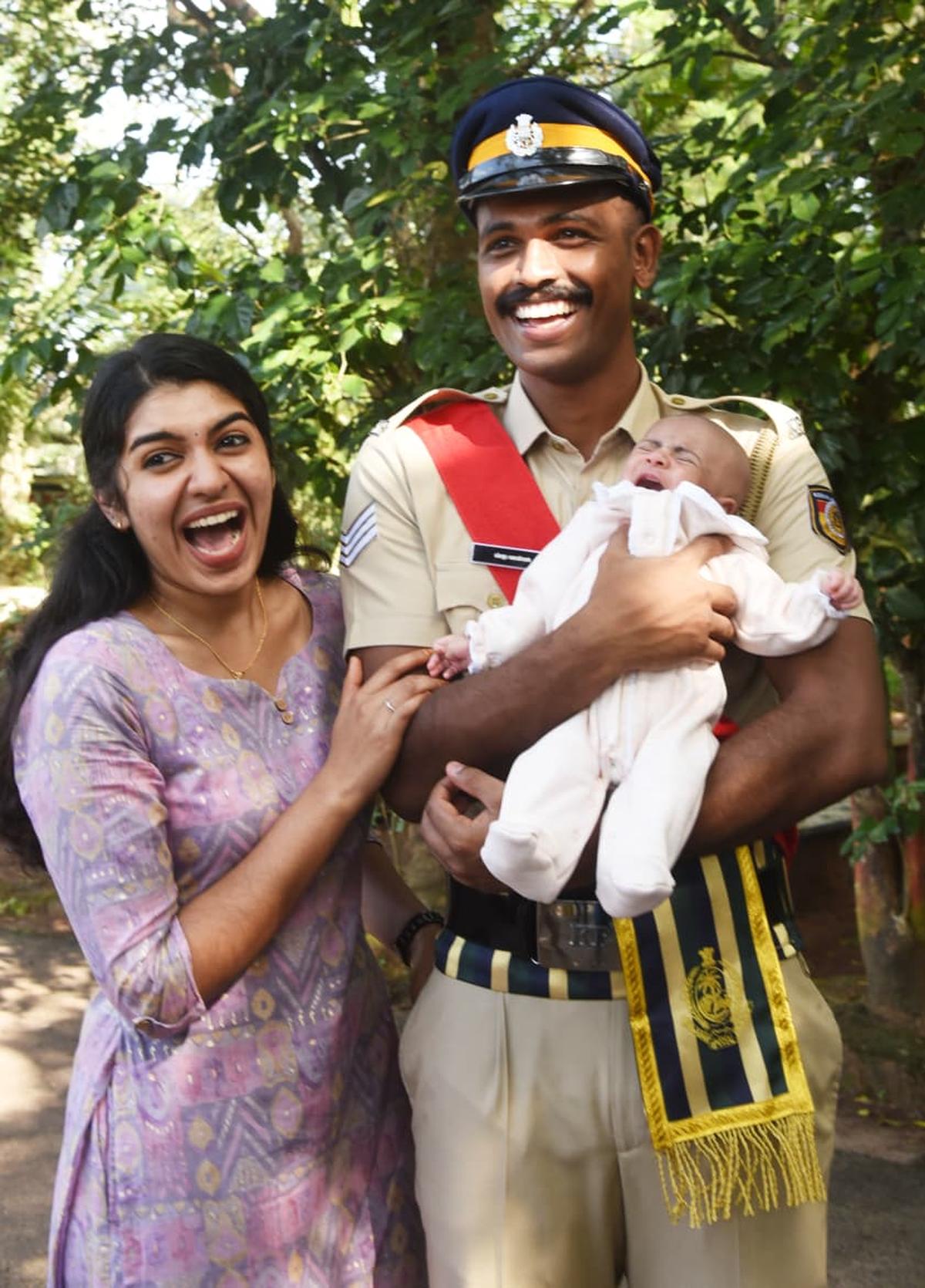 A senior civil police officer sharing his joy with his wife and child after the passing-out parade at MSP grounds, Malappuram, on Monday.