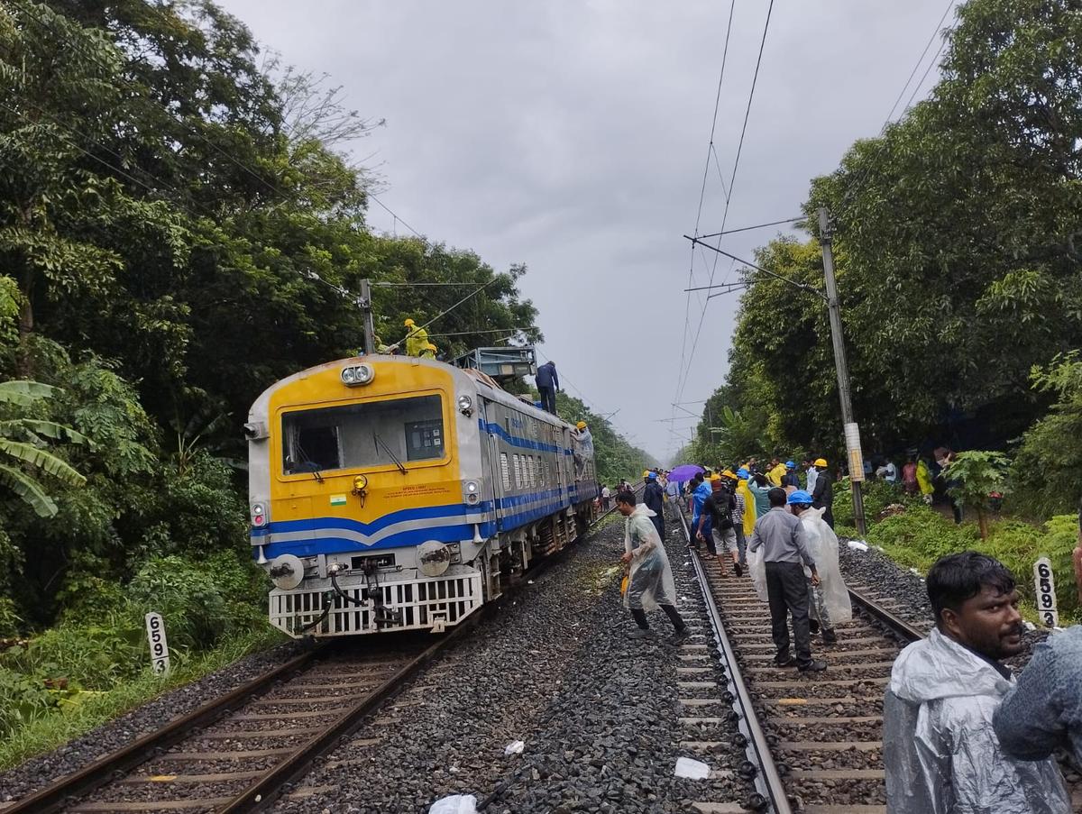 Railway officials clearing the track near Areekkad in Kozhikode on Tuesday after a tree fell on the track and the electric line over it, disrupting traffic for hours on Tuesday morning.