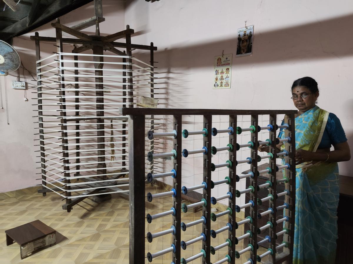 Lekshmi operating the  ‘Raattu’, a spinning wheel, inside her hosue at Saliyar street in Balaramapuram