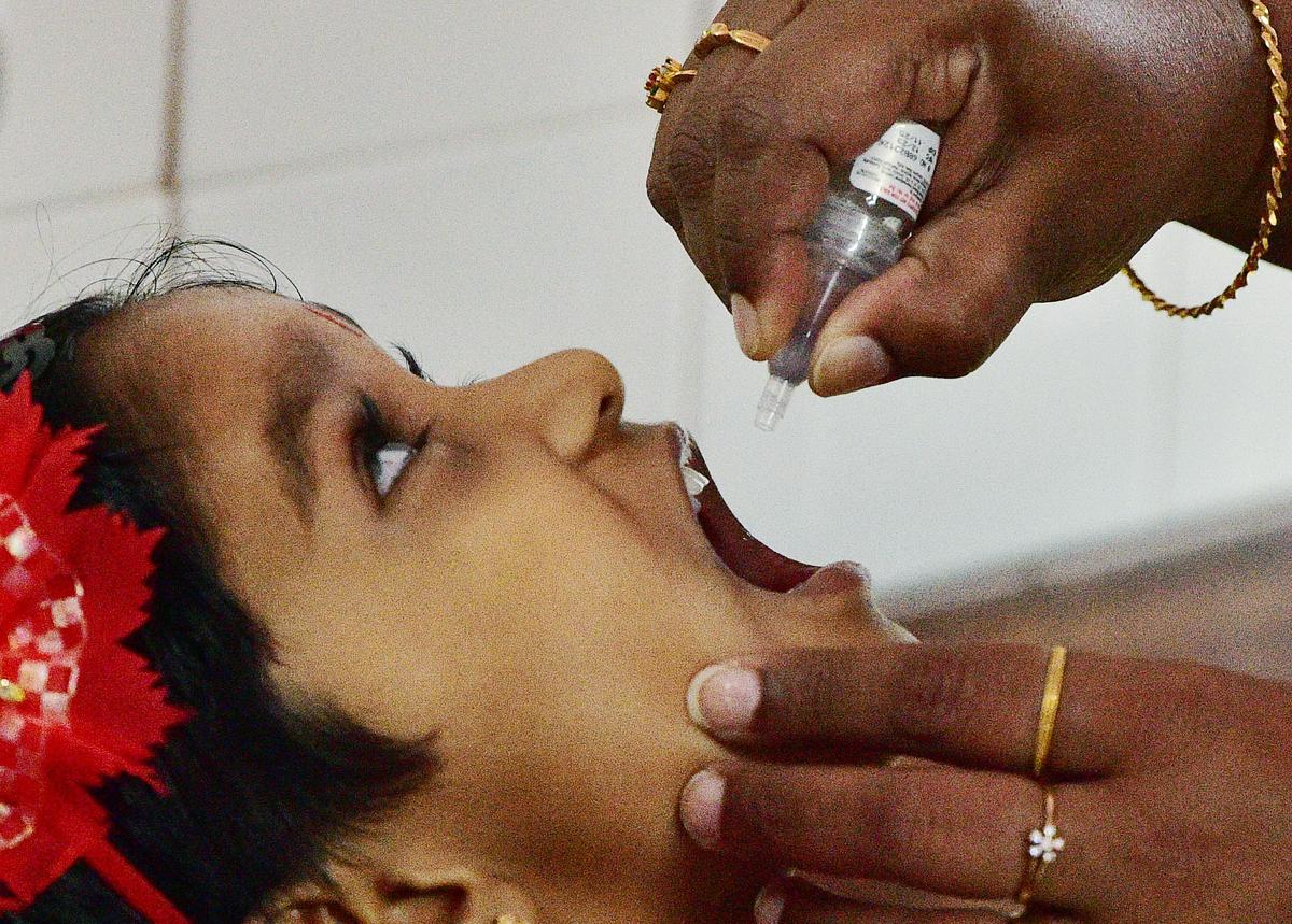 Female literacy has fostered widespread awareness of vaccine-preventable childhood illnesses. The photo shows pulse polio drops being administered to a child at Government Hospital, Palakkad.