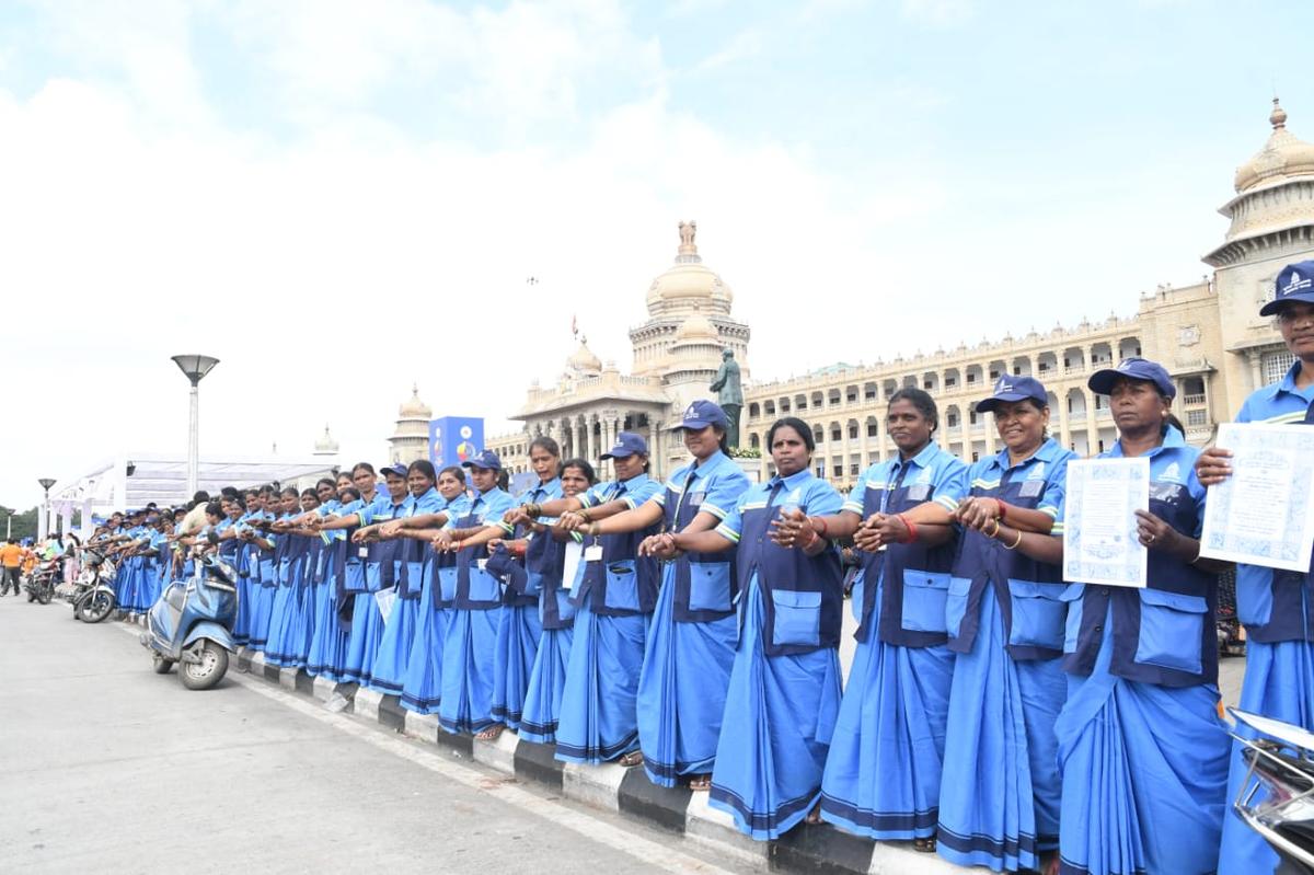 Government officials formed a human chain in front of the DC’s office in Shivamogga on Sunday. 