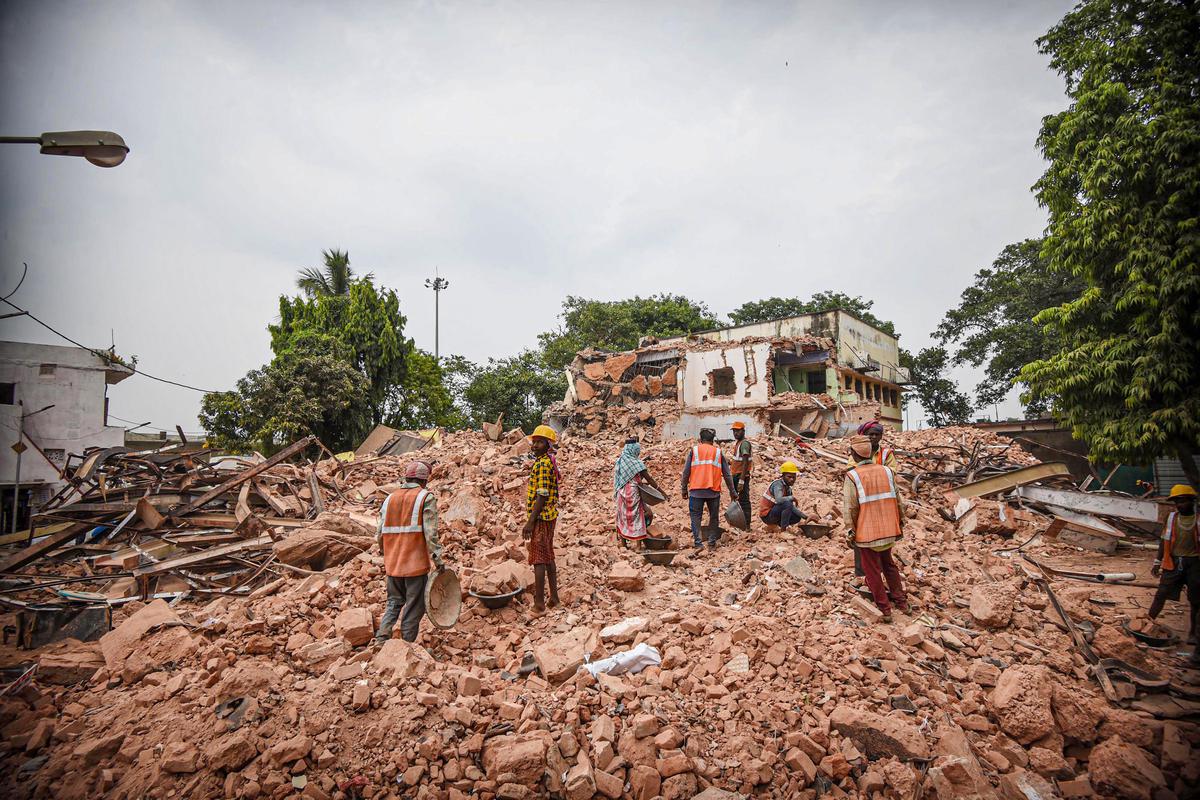 Construction workers among the rubble of the District Magistrate's office building at the Patna Collectorate campus, June 29, 2022.